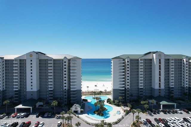 view of city with a beach view and a water view