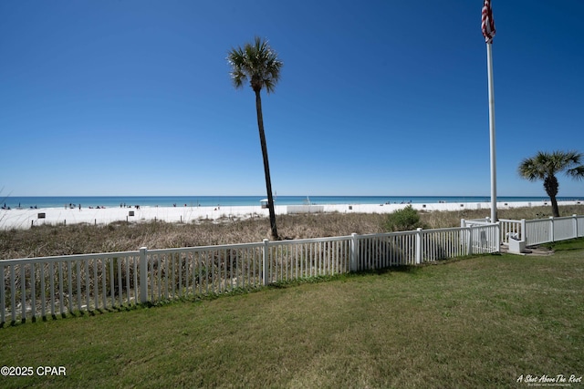 property view of water featuring a view of the beach and fence