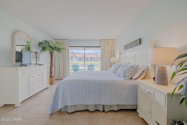 bedroom with light tile patterned floors, vaulted ceiling, a textured ceiling, and access to outside