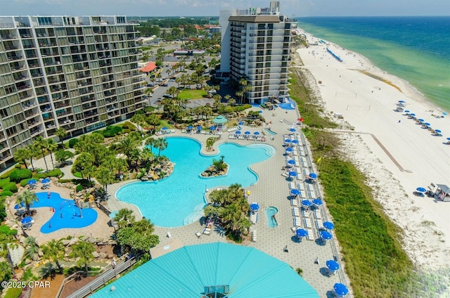 drone / aerial view with a beach view and a water view