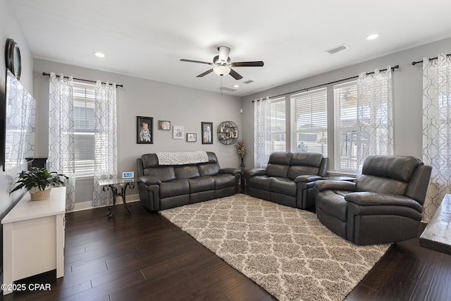 living room with baseboards, visible vents, a ceiling fan, dark wood-style flooring, and recessed lighting