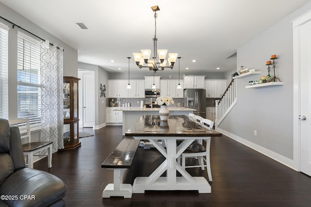 dining room with visible vents, baseboards, dark wood-style floors, an inviting chandelier, and recessed lighting