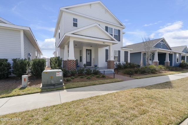 view of front of property featuring a porch and a front yard