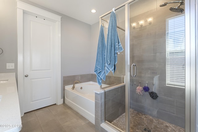 bathroom featuring tile patterned flooring, a shower stall, and a bath