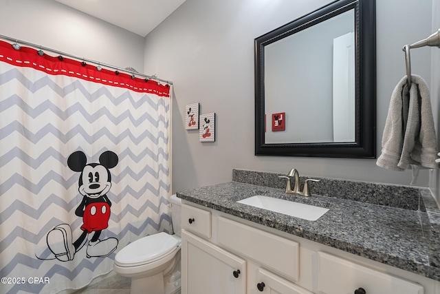 bathroom featuring curtained shower, vanity, and toilet