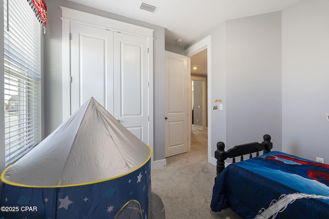 carpeted bedroom featuring visible vents