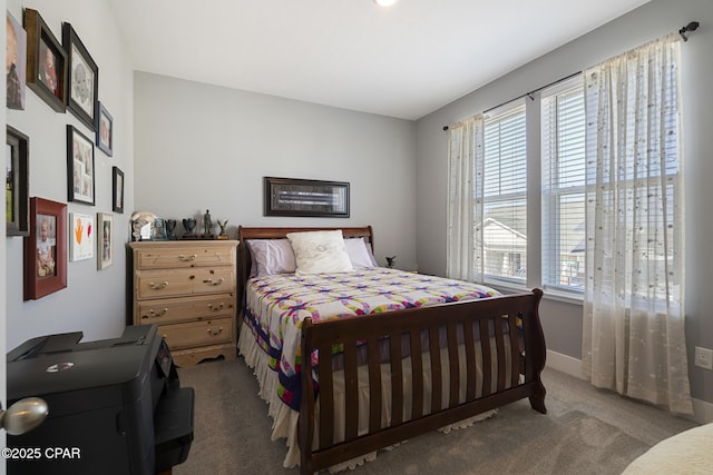 bedroom featuring baseboards and carpet flooring