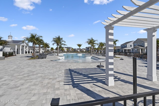 community pool featuring a patio, a residential view, and a pergola