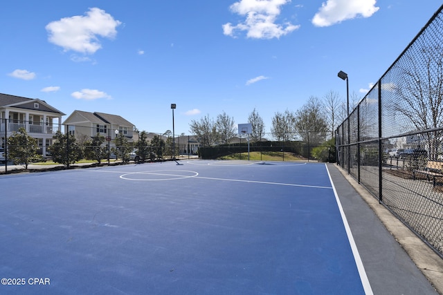 view of sport court featuring community basketball court and fence