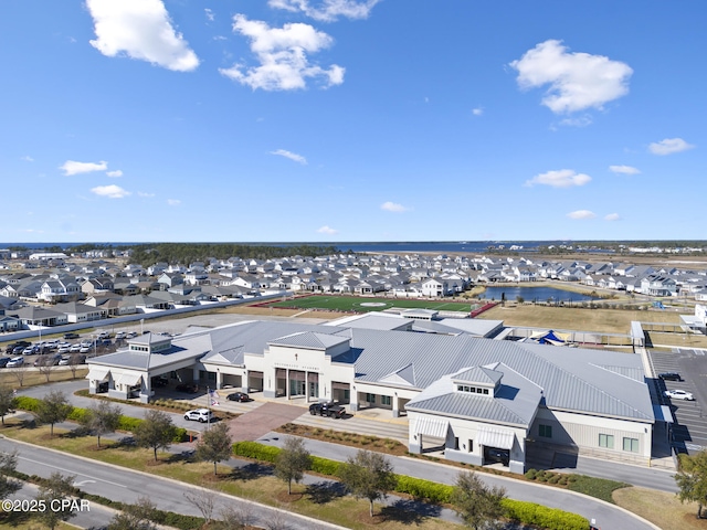 birds eye view of property with a water view and a residential view