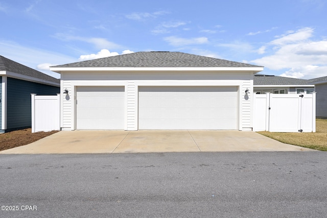 garage with a gate and fence