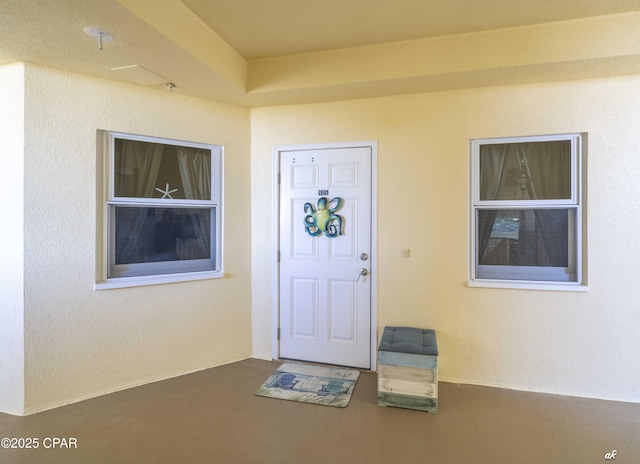 view of exterior entry with stucco siding