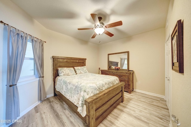 bedroom featuring a ceiling fan, light wood-type flooring, and baseboards