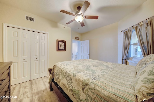 bedroom featuring visible vents, a closet, a ceiling fan, and light wood finished floors