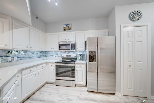 kitchen featuring tasteful backsplash, appliances with stainless steel finishes, light countertops, and white cabinetry