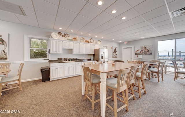 dining room with recessed lighting, a drop ceiling, light carpet, and baseboards