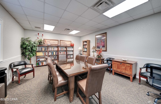 home office with visible vents, carpet flooring, and a paneled ceiling