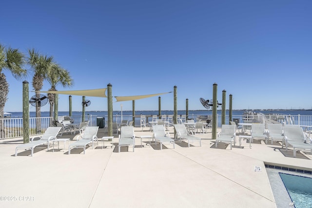 exterior space with a water view, a patio, and fence