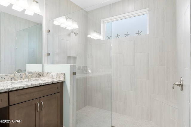 full bathroom featuring walk in shower and vanity