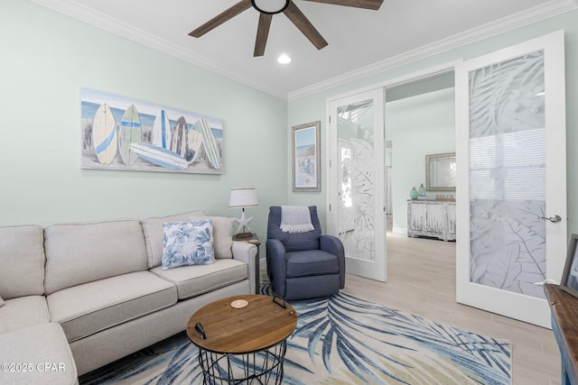 living room with crown molding, baseboards, recessed lighting, wood finished floors, and a ceiling fan