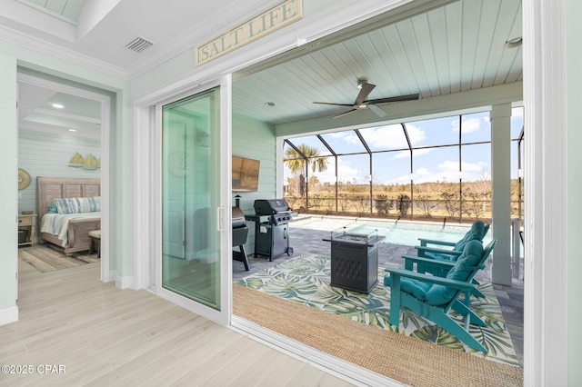 exterior space with a lanai, grilling area, visible vents, and ceiling fan