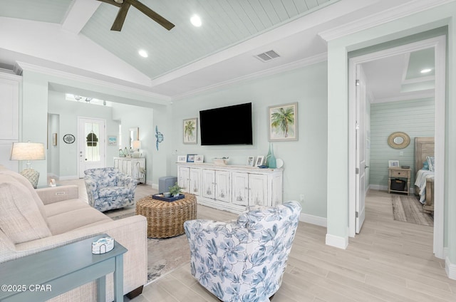 living area with visible vents, vaulted ceiling with beams, crown molding, baseboards, and light wood-style flooring