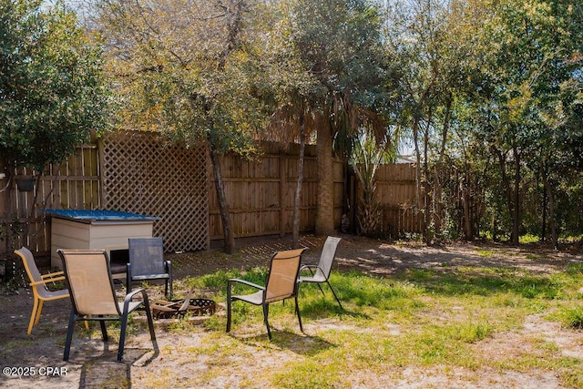 view of yard featuring a fire pit and fence