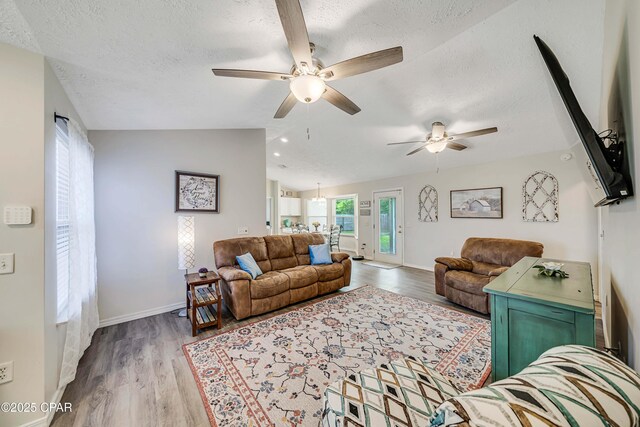 1705 Rhett Pl, Lynn Haven, FL 32444 - living area with a ceiling fan, a textured ceiling, wood finished floors, baseboards, and lofted ceiling