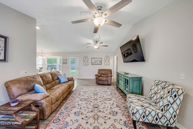 1705 Rhett Pl, Lynn Haven, FL 32444 - living room with wood finished floors, a ceiling fan, baseboards, lofted ceiling, and a chandelier