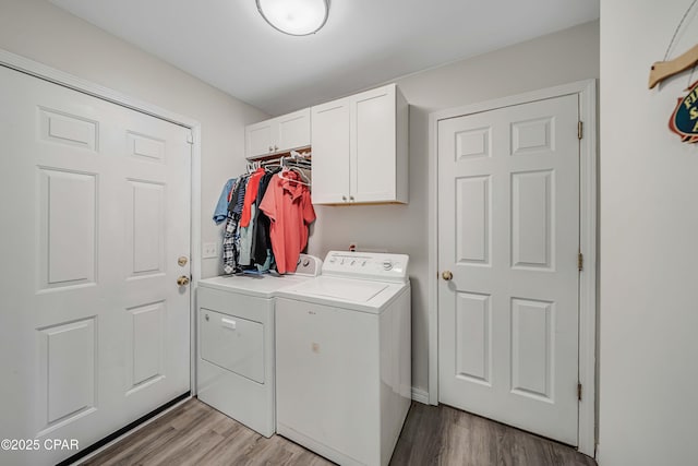 1705 Rhett Pl, Lynn Haven, FL 32444 - laundry room with washing machine and dryer, cabinet space, and light wood-type flooring