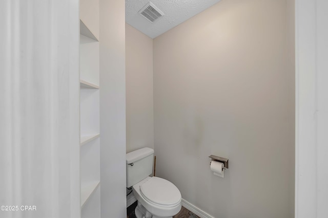 1705 Rhett Pl, Lynn Haven, FL 32444 - bathroom featuring toilet, baseboards, and a textured ceiling