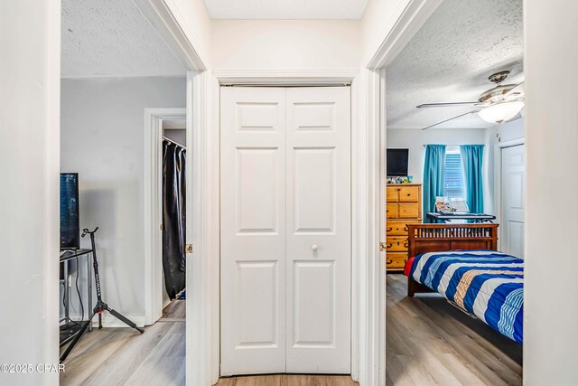1705 Rhett Pl, Lynn Haven, FL 32444 - bedroom with a textured ceiling, light wood-style floors, and ceiling fan