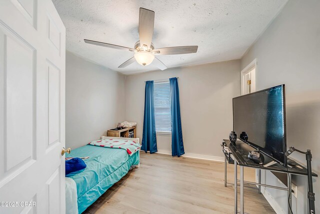 1705 Rhett Pl, Lynn Haven, FL 32444 - bedroom with a textured ceiling, light wood-type flooring, baseboards, and a ceiling fan
