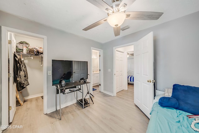 1705 Rhett Pl, Lynn Haven, FL 32444 - bedroom with a spacious closet, light wood finished floors, a closet, baseboards, and ceiling fan