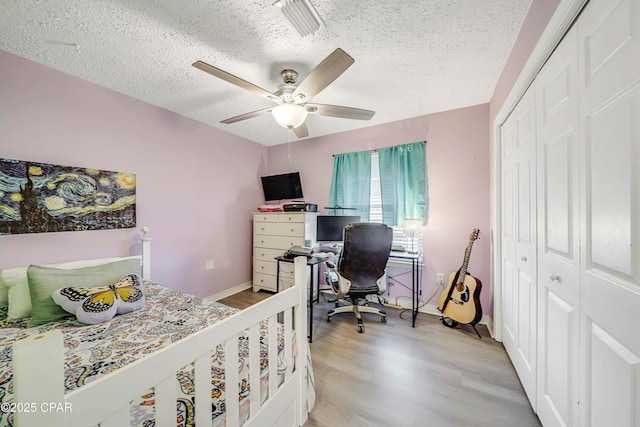 1705 Rhett Pl, Lynn Haven, FL 32444 - bedroom with light wood-style floors, a closet, a textured ceiling, an office area, and baseboards