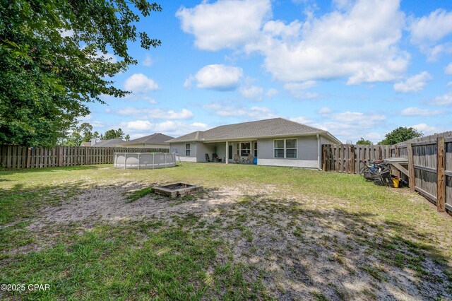 1705 Rhett Pl, Lynn Haven, FL 32444 - rear view of property featuring a fire pit and stucco siding