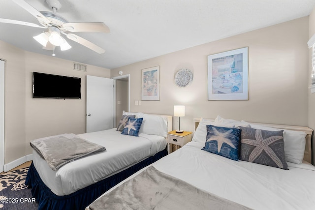 bedroom with visible vents, baseboards, and ceiling fan