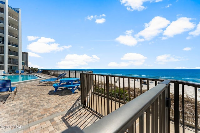 exterior space featuring a water view and a patio