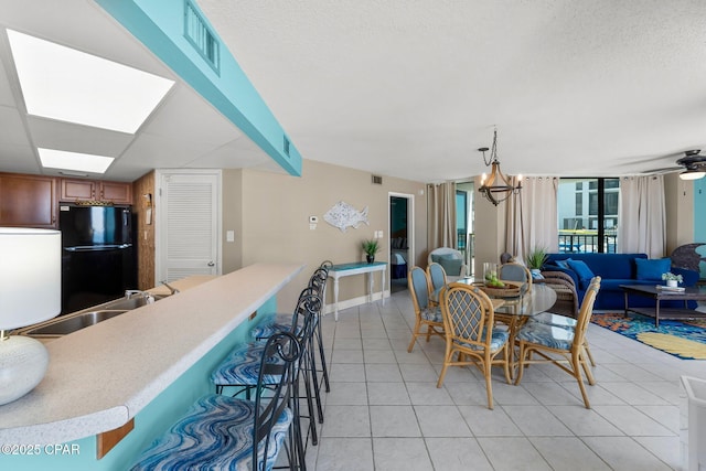 dining room featuring visible vents, a textured ceiling, and light tile patterned flooring