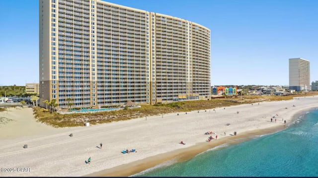 aerial view with a water view, a view of city, and a beach view