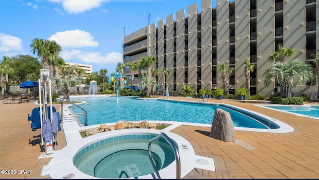 pool featuring a community hot tub and a patio