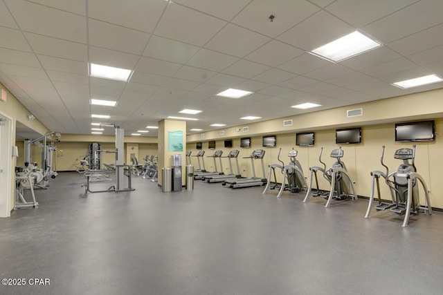 workout area featuring visible vents and a paneled ceiling