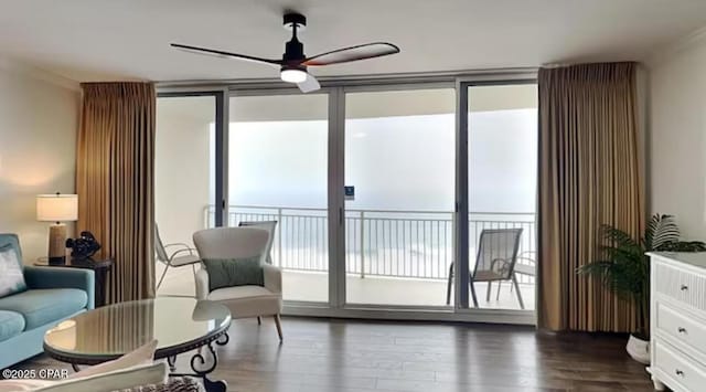 sitting room with wood finished floors and ceiling fan