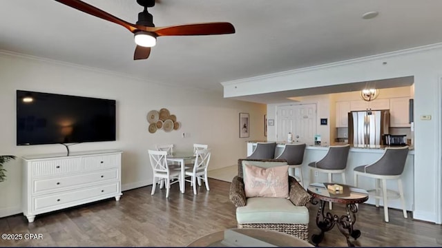 living room featuring dark wood-style floors, baseboards, ceiling fan, and ornamental molding