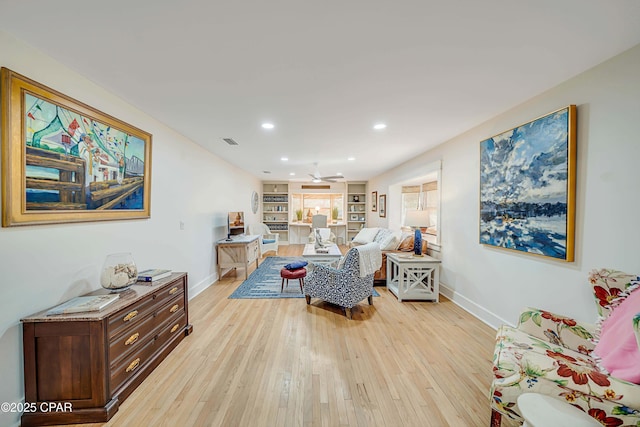 living room featuring light wood finished floors, recessed lighting, visible vents, and baseboards