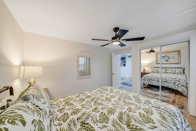 bedroom featuring a closet, a ceiling fan, and wood finished floors