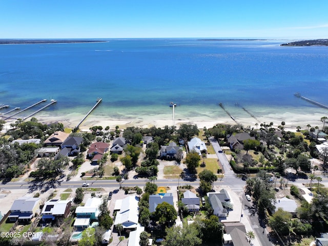 bird's eye view featuring a view of the beach, a residential view, and a water view