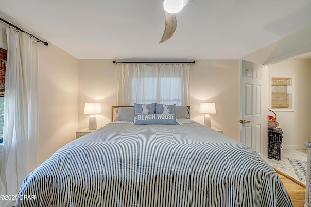 bedroom featuring ceiling fan and wood finished floors