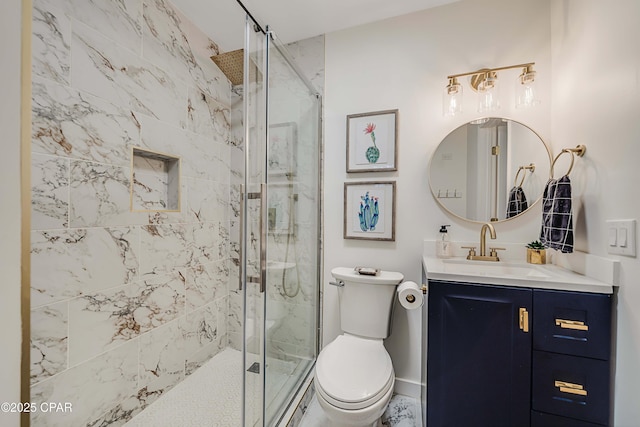 full bath with vanity, a shower stall, and toilet