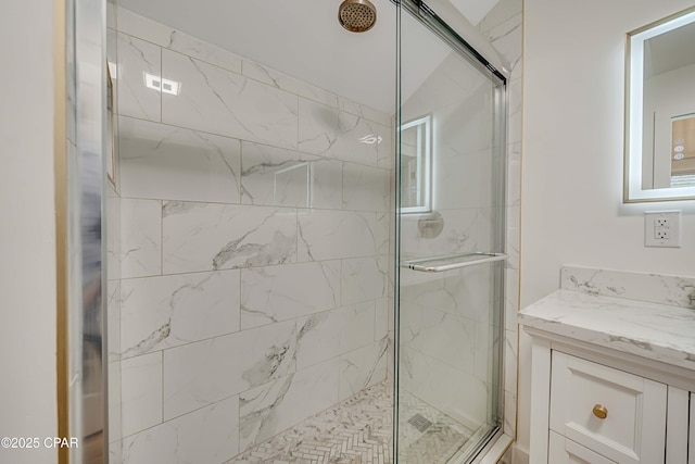 bathroom featuring a shower stall and vanity